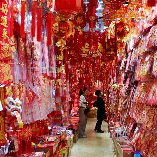 People shop decorations ahead of Spring Festival in Guangzhou